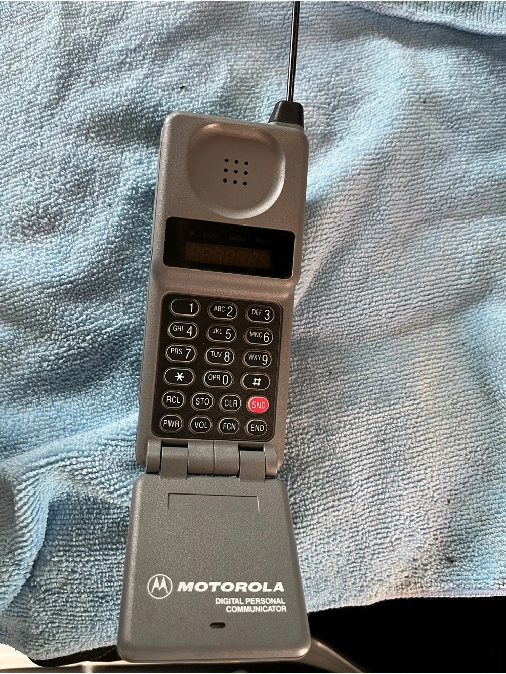 Motorola Silver Flip Phone with Numeric Keypad and Antenna